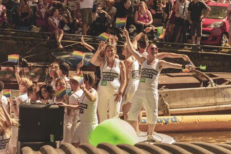 Amsterdam, Netherlands - August 3, 2013: A vintage color tone picture  of Amsterdam gay parade in a canal on a sunny day with people having fun dancing on a boatのeditorial素材