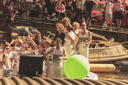 Amsterdam, Netherlands - August 3, 2013: A vintage color tone picture  of Amsterdam gay parade in a canal on a sunny day with people having fun dancing on a boatのeditorial素材
