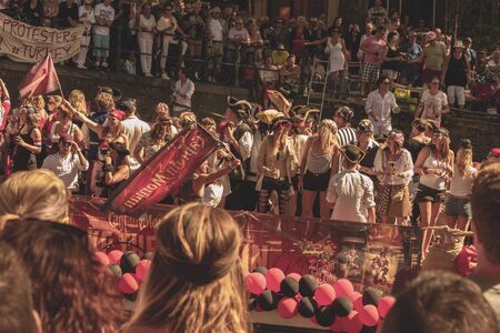 Amsterdam, Netherlands - August 3, 2013: A vintage color tone picture  of Amsterdam gay parade in a canal on a sunny day with people having fun dancing on a boatのeditorial素材