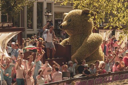 Amsterdam, Netherlands - August 3, 2013: A vintage color tone picture  of Amsterdam gay parade in a canal on a sunny day with people having fun dancing on a boatのeditorial素材