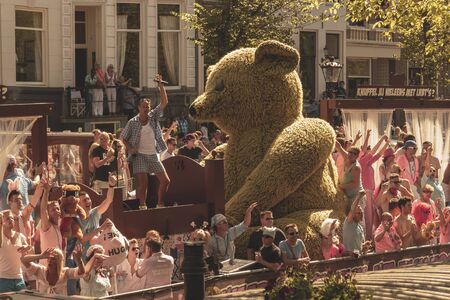 Amsterdam, Netherlands - August 3, 2013: A vintage color tone picture  of Amsterdam gay parade in a canal on a sunny day with people having fun dancing on a boatのeditorial素材