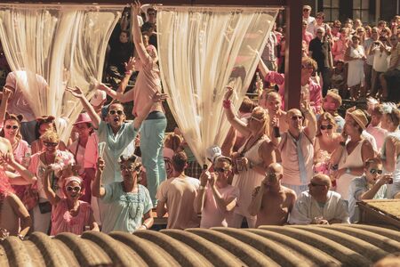 Amsterdam, Netherlands - August 3, 2013: A vintage color tone picture  of Amsterdam gay parade in a canal on a sunny day with people having fun dancing on a boatのeditorial素材