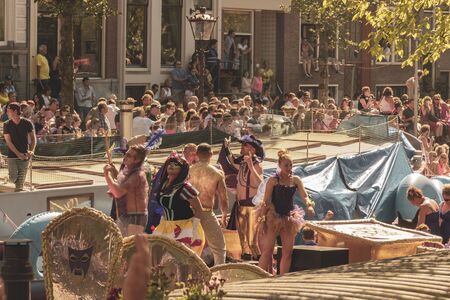 Amsterdam, Netherlands - August 3, 2013: A vintage color tone picture  of Amsterdam gay parade in a canal on a sunny day with people having fun dancing on a boatのeditorial素材