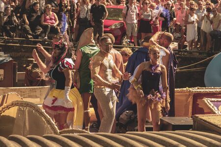 Amsterdam, Netherlands - August 3, 2013: A vintage color tone picture  of Amsterdam gay parade in a canal on a sunny day with people having fun dancing on a boatのeditorial素材