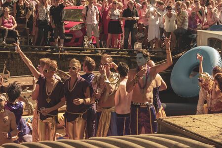 Amsterdam, Netherlands - August 3, 2013: A vintage color tone picture  of Amsterdam gay parade in a canal on a sunny day with people having fun dancing on a boatのeditorial素材