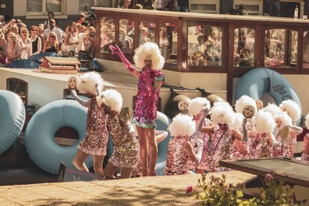 Amsterdam, Netherlands - August 3, 2013: A vintage color tone picture  of Amsterdam gay parade in a canal on a sunny day with people having fun dancing on a boatのeditorial素材