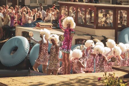 Amsterdam, Netherlands - August 3, 2013: A vintage color tone picture  of Amsterdam gay parade in a canal on a sunny day with people having fun dancing on a boatのeditorial素材