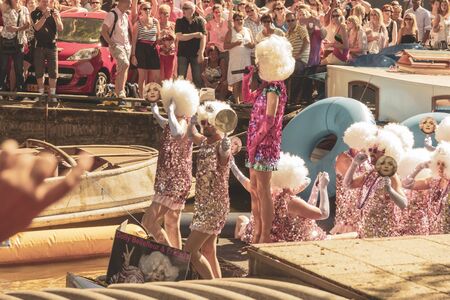 Amsterdam, Netherlands - August 3, 2013: A vintage color tone picture  of Amsterdam gay parade in a canal on a sunny day with people having fun dancing on a boatのeditorial素材