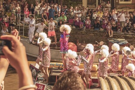 Amsterdam, Netherlands - August 3, 2013: A vintage color tone picture  of Amsterdam gay parade in a canal on a sunny day with people having fun dancing on a boatのeditorial素材
