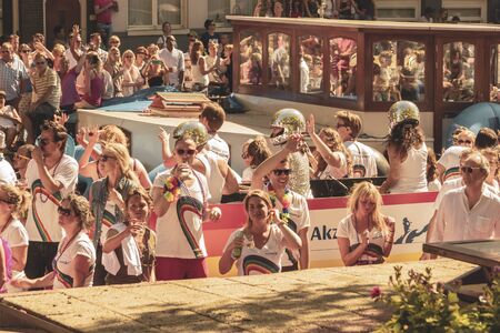 Amsterdam, Netherlands - August 3, 2013: A vintage color tone picture  of Amsterdam gay parade in a canal on a sunny day with people having fun dancing on a boatのeditorial素材