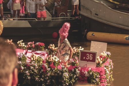 Amsterdam, Netherlands - August 3, 2013: A vintage color tone picture  of Amsterdam gay parade in a canal on a sunny day with people having fun dancing on a boatのeditorial素材