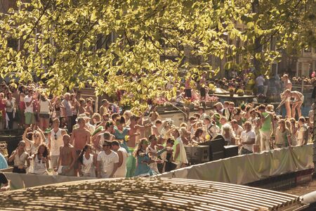 Amsterdam, Netherlands - August 3, 2013: A vintage color tone picture  of Amsterdam gay parade in a canal on a sunny day with people having fun dancing on a boatのeditorial素材
