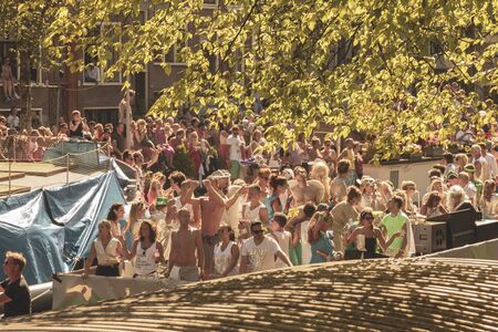 Amsterdam, Netherlands - August 3, 2013: A vintage color tone picture  of Amsterdam gay parade in a canal on a sunny day with people having fun dancing on a boatのeditorial素材