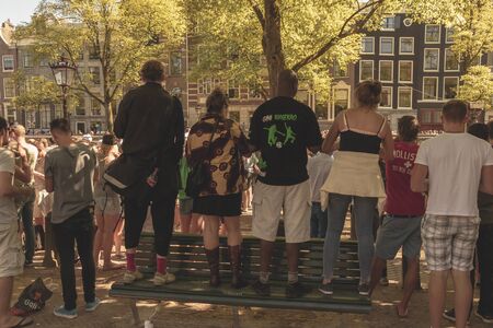 Amsterdam, Netherlands - August 3, 2013: A vintage color tone picture  of Amsterdam gay parade in a canal on a sunny day with people having fun dancing on a boatのeditorial素材