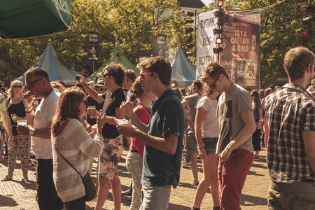 Amsterdam, Netherlands - August 3, 2013: A vintage color tone picture  of Amsterdam gay parade in a canal on a sunny day with people having fun dancing on a boatのeditorial素材
