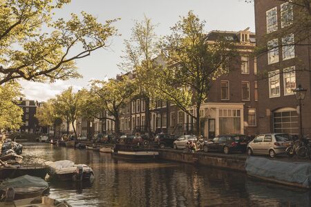 Amsterdam, Netherlands - August 3, 2013: A vintage color tone picture  of Amsterdam gay parade in a canal on a sunny day with people having fun dancing on a boatのeditorial素材