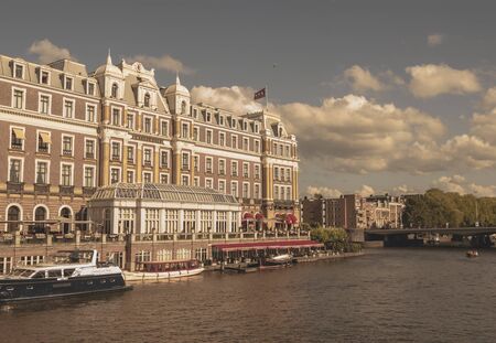 Amsterdam, Netherlands - August 3, 2013: A vintage color tone picture  of Amsterdam gay parade in a canal on a sunny day with people having fun dancing on a boatのeditorial素材
