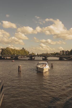 Amsterdam, Netherlands - August 3, 2013: A vintage color tone picture  of Amsterdam gay parade in a canal on a sunny day with people having fun dancing on a boatのeditorial素材