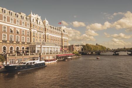 Amsterdam, Netherlands - August 3, 2013: A vintage color tone picture  of Amsterdam gay parade in a canal on a sunny day with people having fun dancing on a boatのeditorial素材