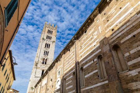 Basilica di San Frediano in Lucca, Italy. Old cozy street in Lucca, Italy. Lucca is a city and comune in Tuscany. It is the capital of the Province of Luccaの写真素材