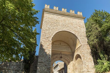 Assisi arch entrance Porta Nuova during sunny day.の写真素材