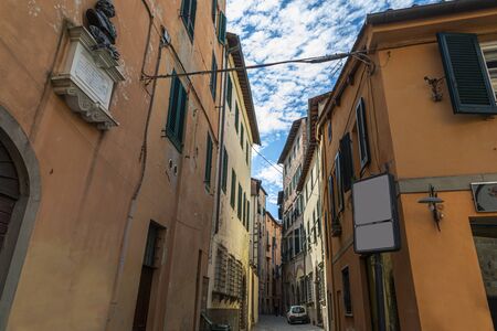 Narrow old cozy street in Lucca, Italy. Lucca is a city and comune in Tuscany. It is the capital of the Province of Luccaの写真素材