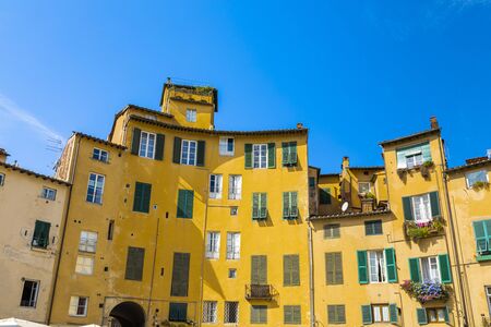 Beautiful colorful building on square - Piazza dell Anfiteatro in Lucca. Tuscany, Italyの写真素材