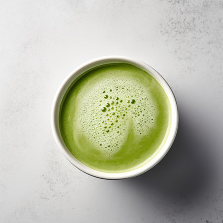 Green matcha latte in a bowl on white background, top viewの素材