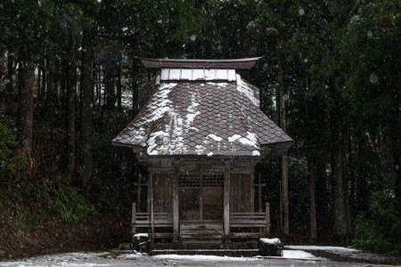It snows gently in a small shrineの写真素材