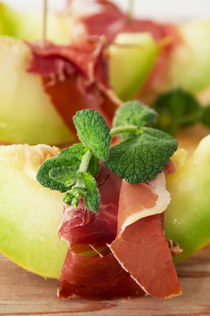 Concept of spanish food with melon and prosciuttoの写真素材