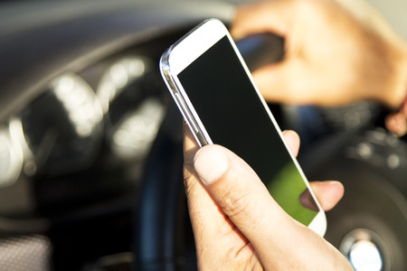 man inside the car with mobile phoneの写真素材