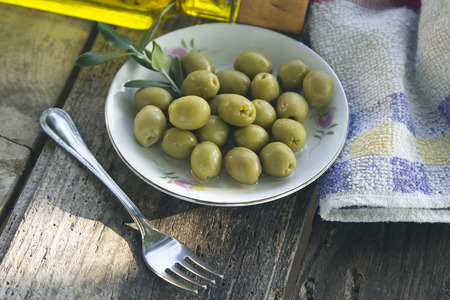 dish of olives on wooden backgroundの写真素材