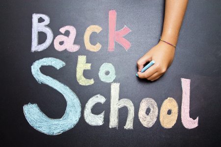 concept back to school, painted on the board with hands of childrenの写真素材