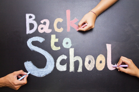 concept back to school, painted on the board with hands of childrenの写真素材