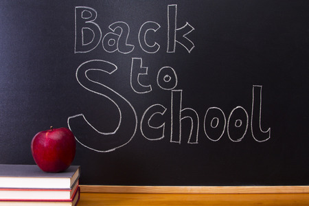back to school written on the blackboard with chalkの写真素材