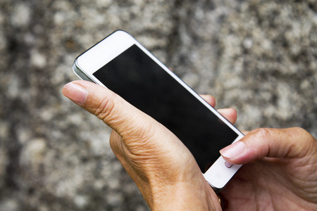 hands of senior woman with mobile phoneの写真素材