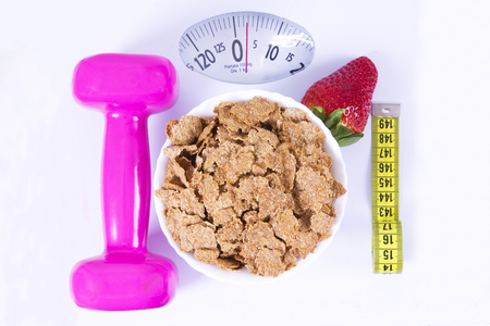 strawberries, cereals, dumbbells and tape measureの写真素材
