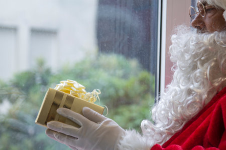 santa claus with gift box in his handsの写真素材
