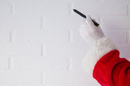 Santa Claus with pen in hand, Christmas greetingの写真素材