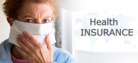 Portrait of senior woman with disposable medical mask and world map. Safety in public places during the coronavirus outbreak.の写真素材