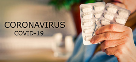 woman holding pill tablets. concept of medicine against infections and coronavirusの写真素材