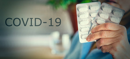 woman holding pill tablets. concept of medicine against infections and coronavirusの写真素材