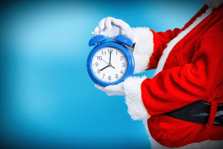 Santa Claus with the alarm clock in his hand