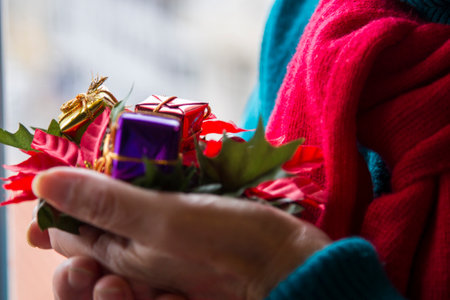 hands holding christmas decorations, merry christmas and new year concept