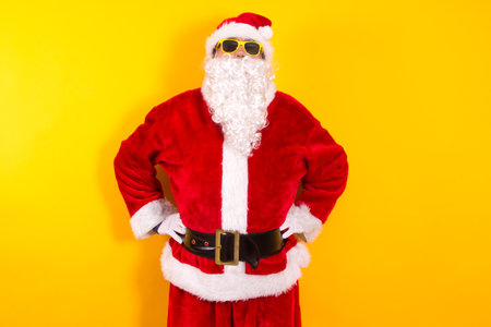 portrait of santa claus with sunglasses on yellow background
