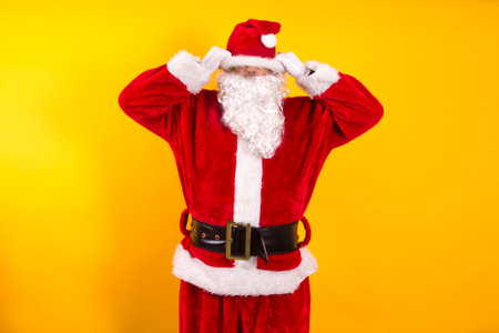 Santa Claus hates Christmas in yellow backgroundの写真素材