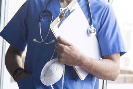 doctor with mask, stethoscope and reports, coronavirus virus concept and infectionsの写真素材