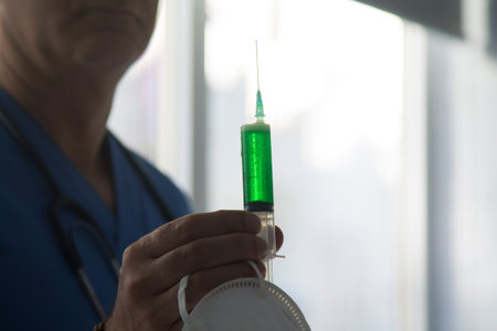 scientist with mask and injection, coronavirus virus conceptの写真素材