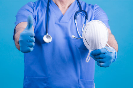 doctor with mask and doing ok symbol, virus and infection conceptの写真素材