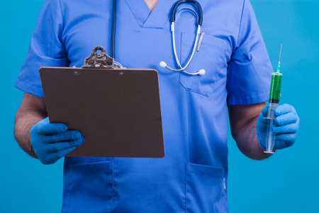 doctor with mask, stethoscope and injection, virus concept and infectionsの写真素材